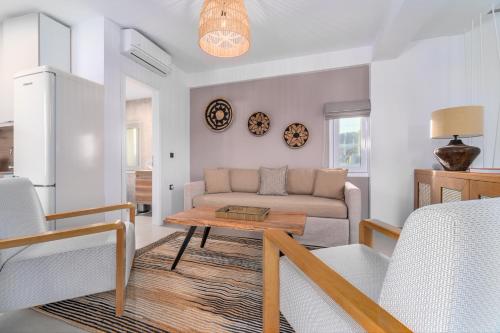 a living room with a couch and a table at Utopia Eco Retreat in Skiathos Town
