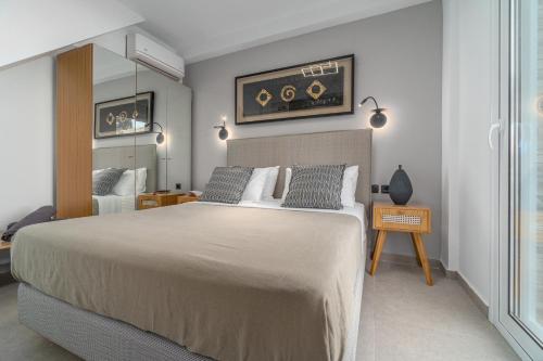 a bedroom with a large bed and a mirror at Utopia Eco Retreat in Skiathos Town