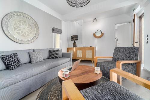 a living room with a couch and a table at Utopia Eco Retreat in Skiathos Town