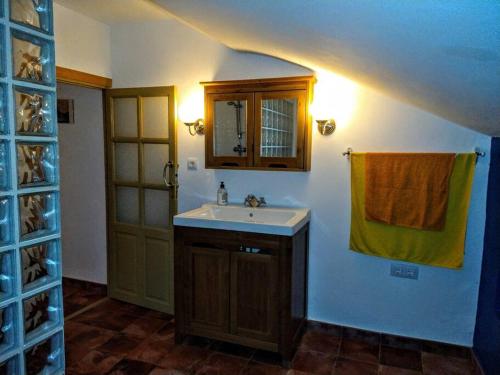 a bathroom with a sink and a mirror and a door at Casa del Agua in Cabeza Gorda