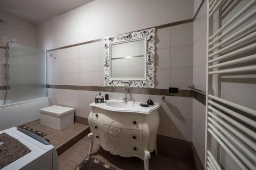 a bathroom with a sink and a mirror on the wall at Galì Holidays Casa Vacanze in Acquedolci