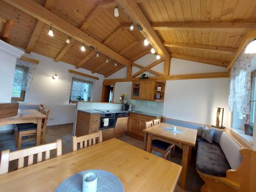 a large kitchen and dining room with wooden ceilings at Wagnerhof in Pichl bei Aussee