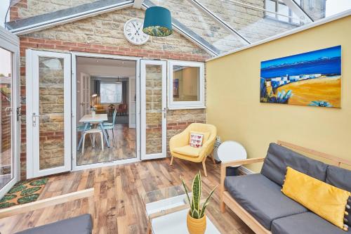 a living room with a couch and a table at Host & Stay - Garden Cottage in Durham