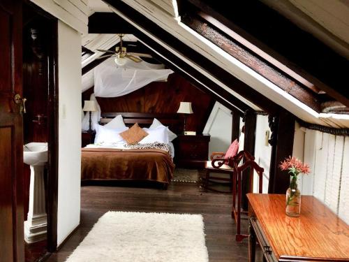 a bedroom with a bed in an attic at Harfield Guest Villa in Cape Town
