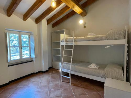 a room with bunk beds and a window at Casa dell'Arco Civico 35 in San Fruttuoso