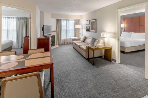 a hotel room with a couch and a bed at Residence Inn Sacramento Rancho Cordova in Rancho Cordova