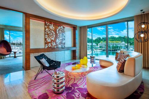 a living room with a couch and a table at W Singapore - Sentosa Cove in Singapore