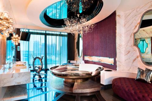 a bathroom with a large bowl sink and a chandelier at W Singapore - Sentosa Cove in Singapore
