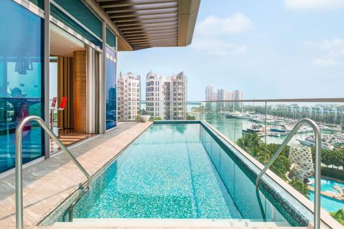 a swimming pool on the roof of a building at W Singapore - Sentosa Cove in Singapore