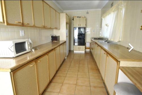 a kitchen with a counter and a microwave in it at House of creations in Diepkloof