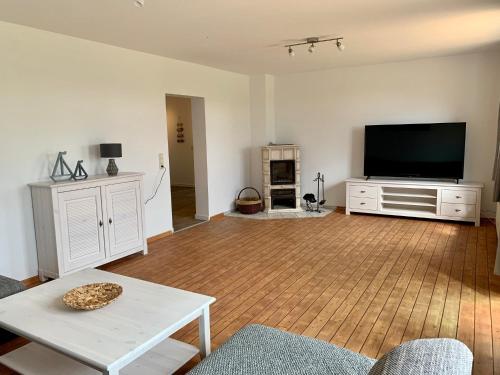 a living room with a large flat screen tv at Sundblick, ideal für Familien in Teschendorf