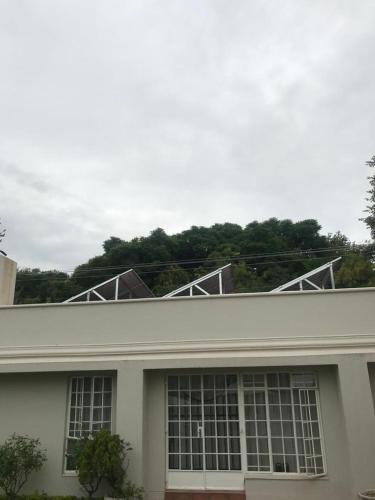 a white building with windows on top of it at Brooklyn Place in Pretoria