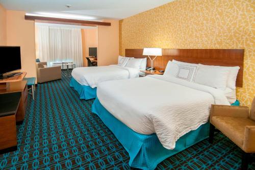 a hotel room with two beds and a television at Fairfield Inn & Suites by Marriott San Antonio Brooks City Base in San Antonio