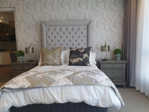 a bedroom with a large bed with two night stands at Menlyn Maine Trilogy Apartment 509 in Pretoria