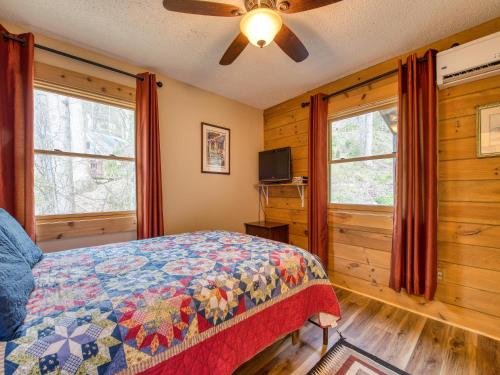 een slaapkamer met een bed en 2 ramen bij Pets! 2 Fireplaces! Game Room! Creek! View! in Maggie Valley