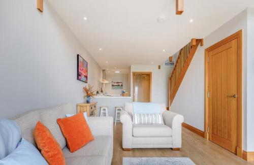 a living room with a couch and a chair at Woodside Apartments in St. Andrews