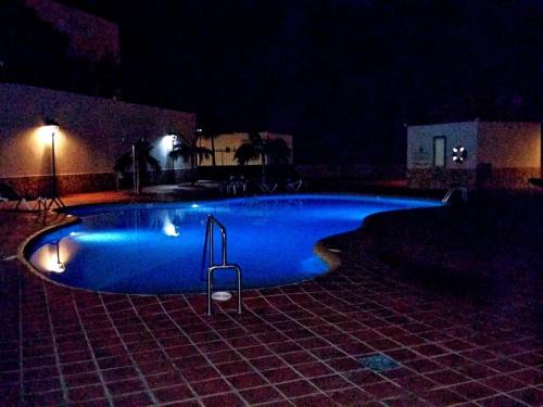a blue swimming pool at night with lights at Costa Adeje Villa Private pool Panoramic Views in Adeje