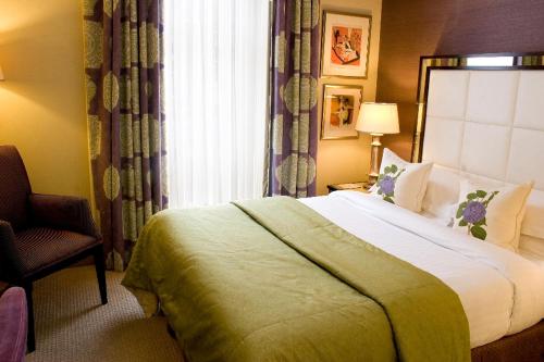 a hotel room with a bed and a chair at The Mandeville Hotel in London