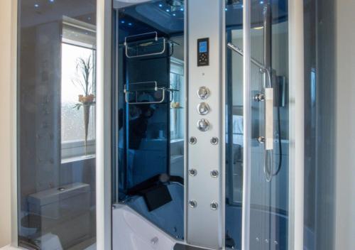 a shower with a glass door in a bathroom at Bishops Hill in Acomb