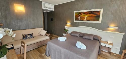 a living room with a bed and a couch at Hotel Meridiana in Bellano