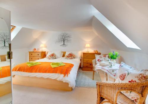 a bedroom with a bed and a table and chairs at Braeside in Wooler