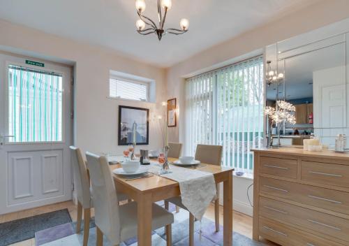 a kitchen and dining room with a table and chairs at Monkey Puzzle Retreat in Belford