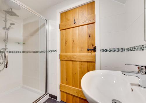 a bathroom with a white sink and a shower at Bowgie in Saint Merryn