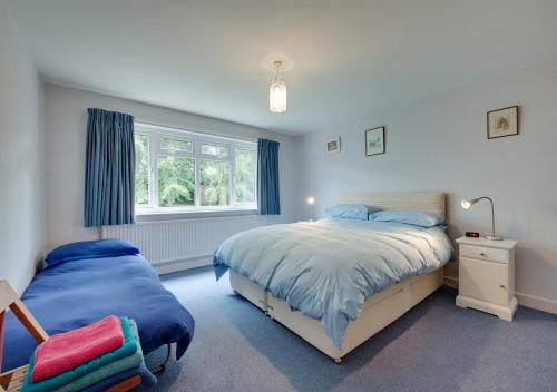 a bedroom with two beds and a window at Middleton View in Ilkley