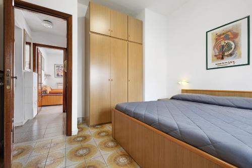 a bedroom with a large bed and a closet at Numero 14 in Borgio Verezzi