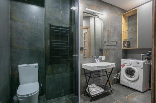 a bathroom with a sink and a washing machine at Luxe Apartment in Center in Yerevan