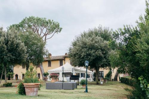 a large yellow house with a piano in the yard at Agriturismo Bellavista in San Miniato