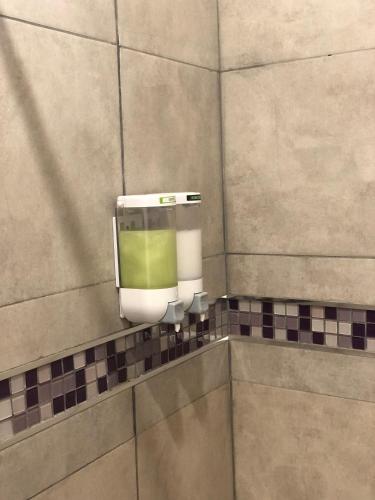 a soap dispenser on the wall of a bathroom at Las Lavandas Purmamarca in Purmamarca