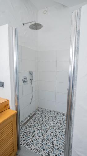 a bathroom with a shower with a tile floor at Salonika Suites in Oludeniz