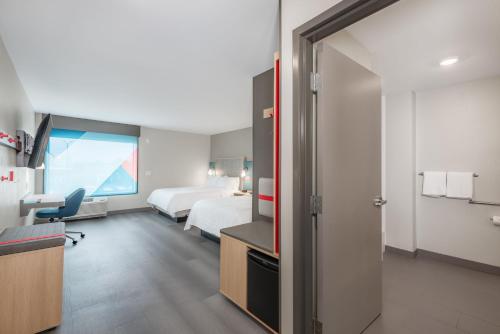 a hotel room with a bed and a desk at avid hotel Nashville - Lebanon an IHG Hotel in Lebanon
