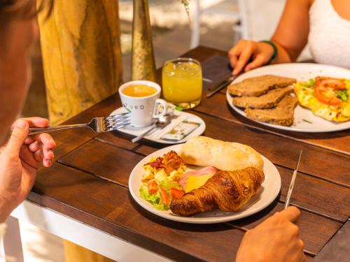 twee mensen aan een tafel met een bord eten bij Resort Bonaire in Kralendijk