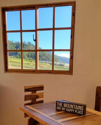 a sign sitting on a table in front of a window at Villas Montelindo in Constanza