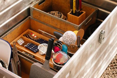 a wooden drawer filled with cooking utensils at Beekeeper's Hut - Hawarden Estate in Hawarden