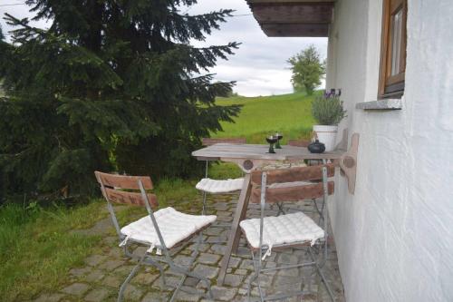 a table and chairs sitting on a patio at Birken Chalet in Falkenfels