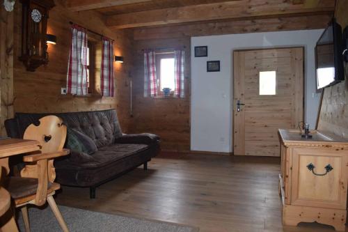 a living room with a couch and a table at Birken Chalet in Falkenfels