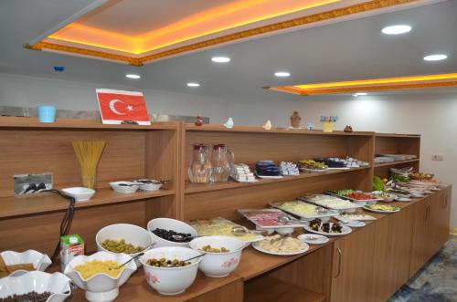 a buffet line with bowls of food on display at Marka Hotel in Antalya