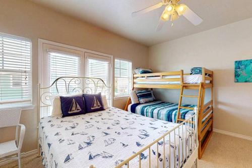 a bedroom with a bed and a bunk bed at Chic 3 BR Home With Pool and Hot Tub in Port Aransas