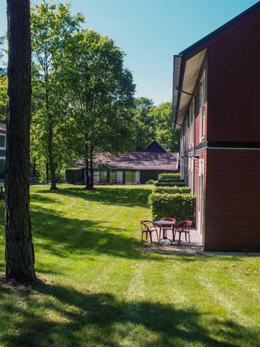 two picnic tables sitting next to a building at Hotel de Stoppelberg in Beekbergen