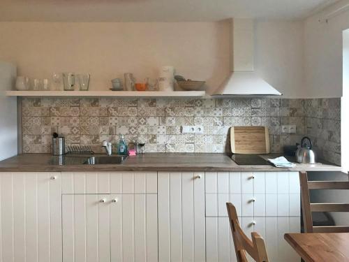 a kitchen with a sink and a counter top at Penzion Kvilda - Luční in Kvilda