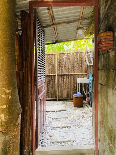an open door to a room with a stone floor at Saigon Garden Homestay in Ho Chi Minh City