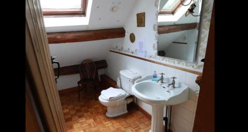 a bathroom with a sink and a toilet and a mirror at Devonshire -Sleeps 19 in 7 ensuite bedrooms great space for all groups in Peak Forest