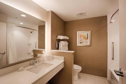 a bathroom with a sink and a toilet and a mirror at Fairfield Inn & Suites by Marriott Clearwater Beach in Clearwater Beach