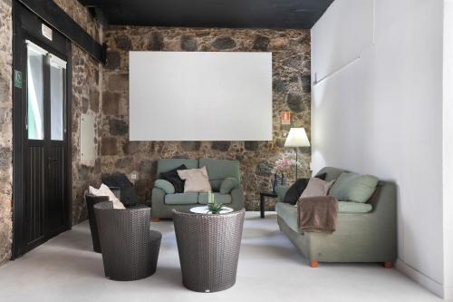 a living room with two couches and a blank canvas at Brothers House in Arrecife