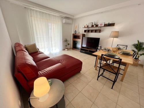 a living room with a couch and a table at Sesimbra Oásis São João in Sesimbra