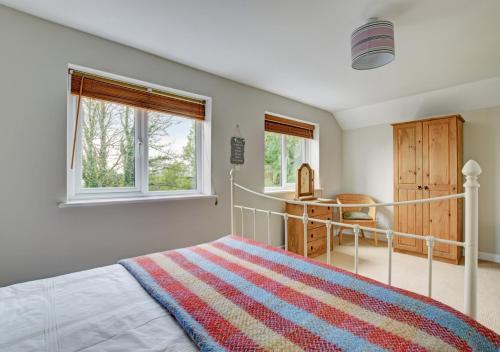 A bed or beds in a room at Tiscott Cottage