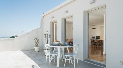 a dining room with a table and chairs on a balcony at Cozy Lisbon Graça in Lisbon